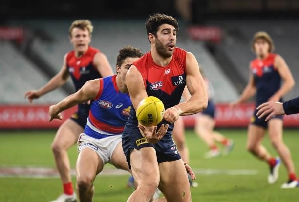 Christian Petracca of the Demons handballs during the round 20 AFL match between Melbourne Demons and Western Bulldogs at Melbourne Cricket Ground on...
