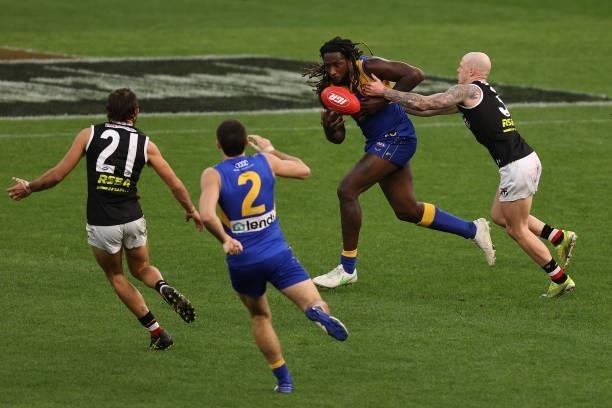 Nic Naitanui of the Eagles looks to break from Zak Jones of the Saints during the round 19 AFL match between West Coast Eagles and St Kilda Saints at...