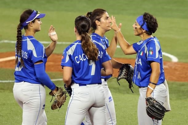 Members of Team Italy high-five at the end of the fifth inning against Team Japan during the Softball Opening Round on day one of the Tokyo 2020...