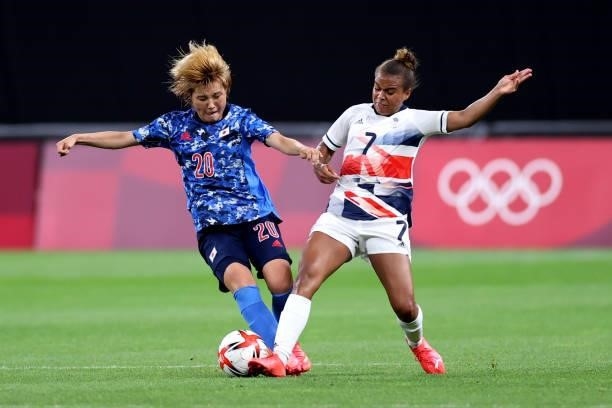Honoka Hayashi of Team Japan is challenged by Nikita Parris of Team Great Britain during the Women's First Round Group E match between Japan and...