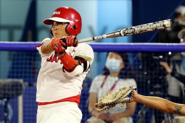 Yu Yamamoto of Team Japan hits a single in the sixth inning against Team Italy during the Softball Opening Round on day one of the Tokyo 2020 Olympic...