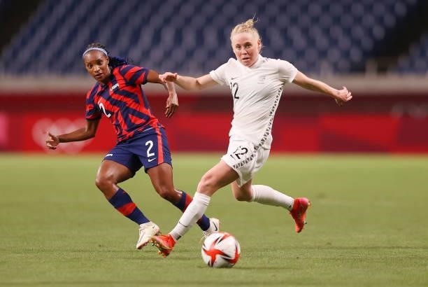 Crystal Dunn of Team United States makes a pass whilst under pressure from Betsy Hassett of Team New Zealand during the Women's First Round Group G...
