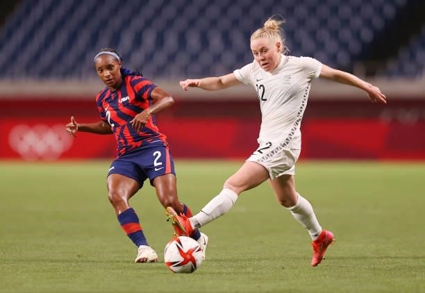 Crystal Dunn of Team United States makes a pass whilst under pressure from Betsy Hassett of Team New Zealand during the Women's First Round Group G...