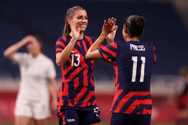 Alex Morgan of Team United States celebrates their side's sixth goal, an own goal by Catherine Bott of Team New Zealand with team mate Christen Press...