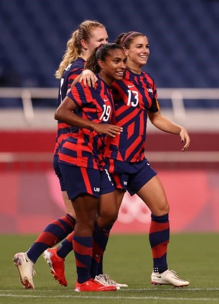 Alex Morgan of Team United States celebrates with Catarina Macario after scoring their side's fifth goal during the Women's First Round Group G match...