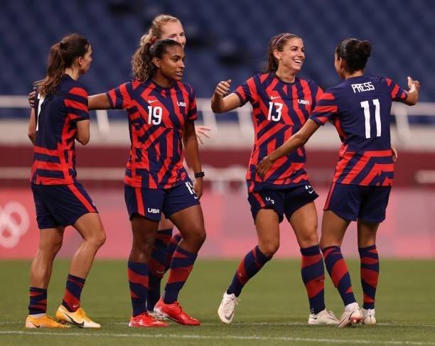 Alex Morgan of Team United States celebrates with Catarina Macario and Christen Press after scoring their side's fifth goal during the Women's First...