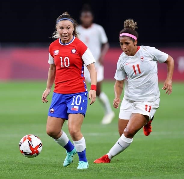 Yanara Aedo of Team Chile is closed down by Desiree Scott of Team Canada during the Women's First Round Group E match between Chile and Canada on day...