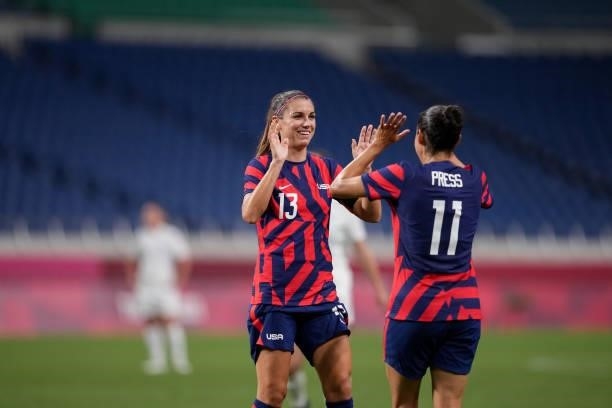 Alex Morgan and Christen Press of the United States celebrate during a game between New Zealand and USWNT at Saitama Stadium on July 24, 2021 in...