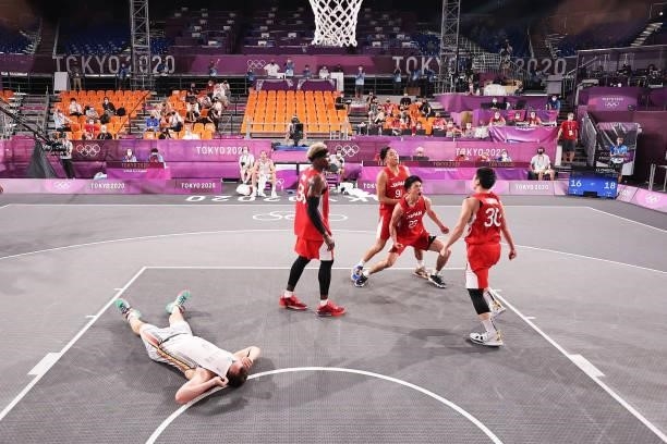 Keisei Tominaga of Team Japan celebrates hitting the winning basket as Nick Celis of Team Belgium lies down during the Men's Pool Round match between...