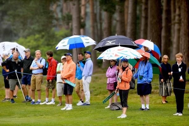 Spectators are seen with umbrellas during day three of The Senior Open Presented by Rolex at Sunningdale Golf Club on July 24, 2021 in Sunningdale,...
