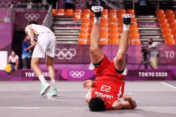 Ryuto Yasuoka of Team Japan falls on the court during the Men's Pool Round match between Belgium and Japan on day one of the Tokyo 2020 Olympic Games...