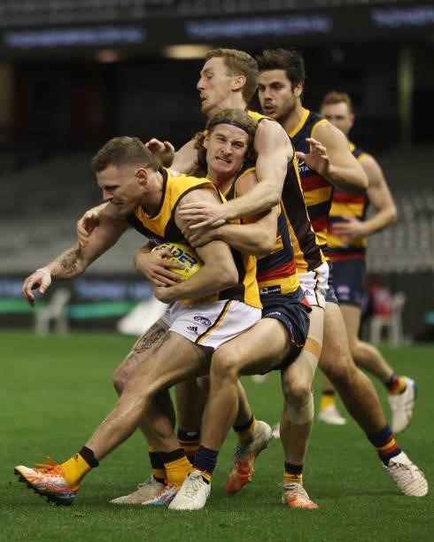 James Worpel of the Hawks is tackled by Sam Berry of the Crows during the round 20 AFL match between Adelaide Crows and Hawthorn Hawks at Marvel...