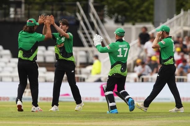 George Garton of Southern Brave celebrates with his teammates after dismissing Alex Hales of Trent Rockets during The Hundred game between Trent...