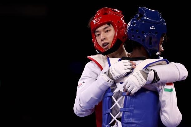 Jang Jun of Team South Korea embraces Omar Salim of Team Hungary during the Men's -58kg Taekwondo Bronze Medal contest on day one of the Tokyo 2020...