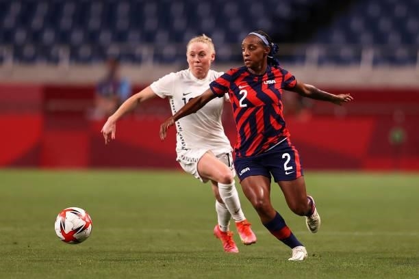 Crystal Dunn of Team United States battles for possession with Betsy Hassett of Team New Zealand during the Women's First Round Group G match between...