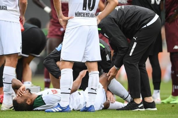 Alassane Plea of Moenchengladbach reacts to an injury at Borussia-Park on July 24, 2021 in Moenchengladbach, Germany.