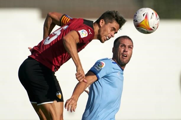 Gabriel Paulista of Valencia CF competes for the ball with Alfredo Ortuno of Cartagena during the pre-season friendly match between Valencia CF and...