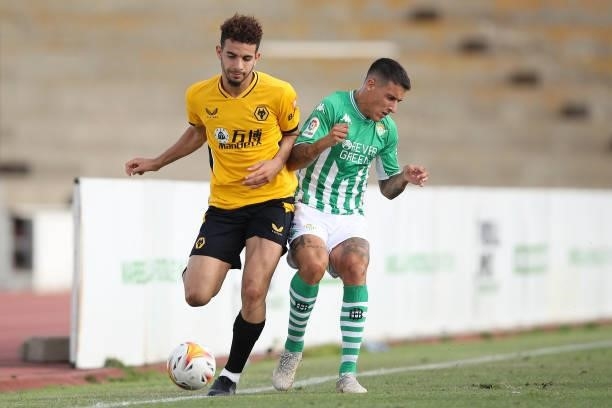 Rayan Ait-Nouri of Wolverhampton Wanderers battles for possession with Cristian Tello of Real Betis during the Pre-Season Friendly match between Real...