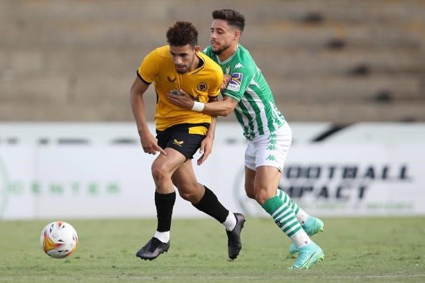 Rayan Ait-Nouri of Wolverhampton Wanderers is challenged by Alex Moreno of Real Betis during the Pre-Season Friendly match between Real Betis and...