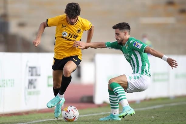 Francisco Trincao of Wolverhampton Wanderers is challenged by Alex Moreno of Real Betis during the Pre-Season Friendly match between Real Betis and...