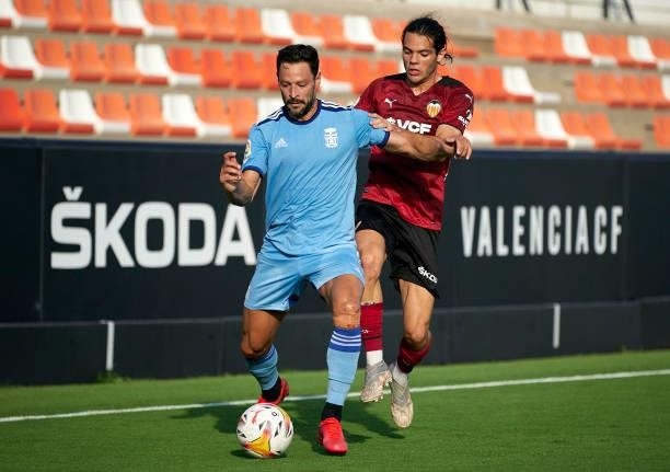 Fran Perez of Valencia CF competes for the ball with Alberto De La Bella of Cartagena during the pre-season friendly match between Valencia CF and FC...