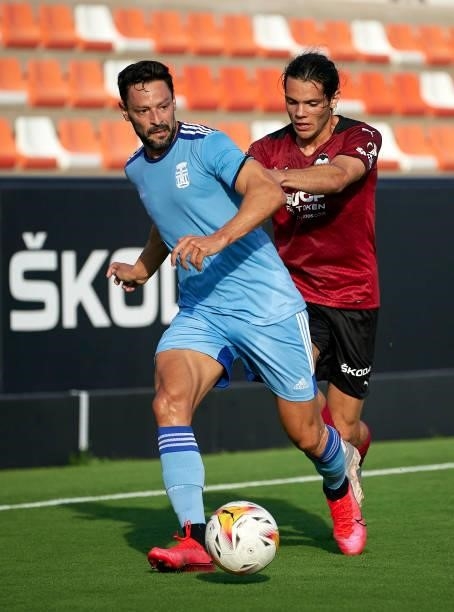 Fran Perez of Valencia CF competes for the ball with Alberto De La Bella of Cartagena during the pre-season friendly match between Valencia CF and FC...