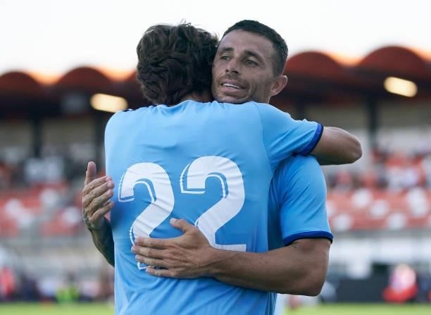 Ruben Castro of Cartagena celebrates after scoring his team's first goal with his teammate Delmas during the pre-season friendly match between...