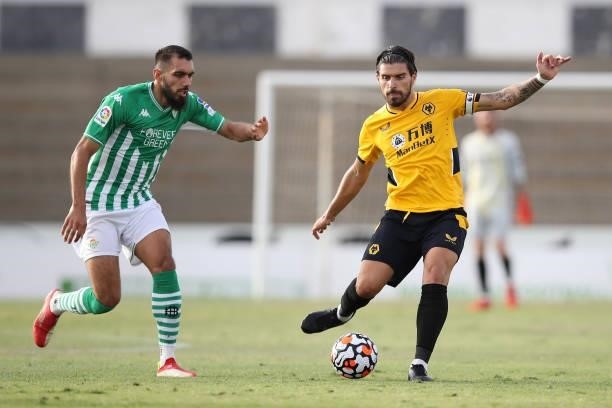 Ruben Neves of Wolverhampton Wanderers is challenged by Borja Iglesias of Real Betis during the Pre-Season Friendly match between Real Betis and...