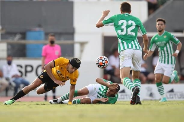 Raul Jimenez of Wolverhampton Wanderers is challenged by Victor Ruiz of Real Betis during the Pre-Season Friendly match between Real Betis and...