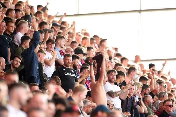 Aston Villa fans cheer during a pre-season friendly match between Stoke City and Aston Villa at Britannia Stadium on July 24, 2021 in Stoke on Trent,...