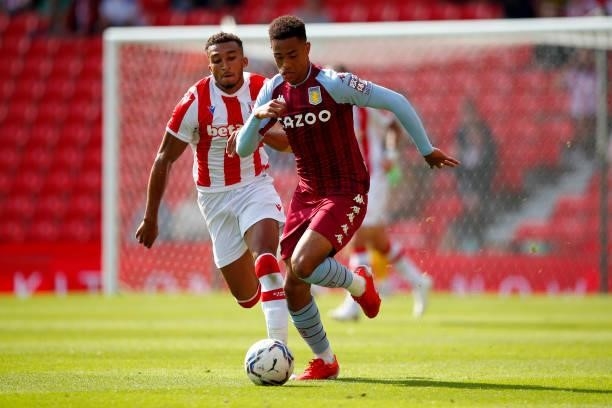 Aaron Ramsey of Aston Villa is challenged by Jacob Brown of Stoke City during the Pre-Season Friendly between Stoke City and Aston Villa at bet365...