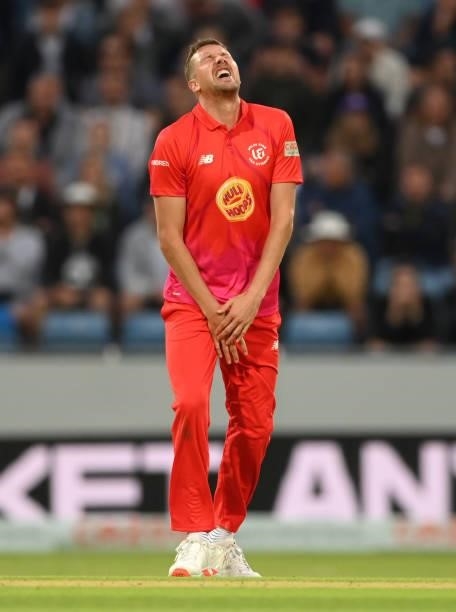 Welsh Fire bowler Jake Ball reacts after his hand stops a ball from a Matthew Potts shot during The Hundred match between Northern Superchargers Men...