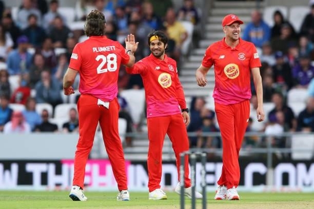 Qais Ahmad of Welsh Fire celebrates with Liam Plunkett and Jake Ball of Welsh Fire after dismissing Harry Brook of Northern Superchargers during The...