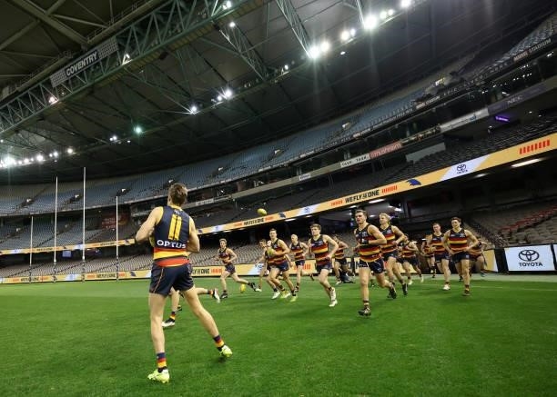 Paul Seedsman of the Crows leads out the team during the round 20 AFL match between Adelaide Crows and Hawthorn Hawks at Marvel Stadium on July 24,...