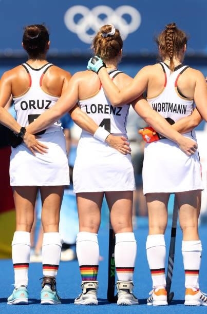 Selin Oruz, Nike Lorenz and Amelie Wortmann of Team Germany stand for the national anthem prior to the Women's Pool A match against Team Great...