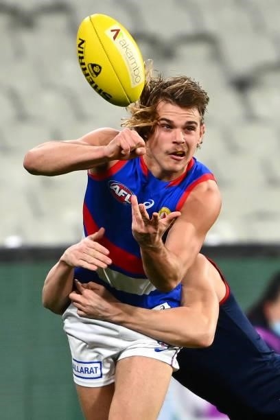 Bailey Smith of the Bulldogs handballs whilst being tackled during the round 20 AFL match between Melbourne Demons and Western Bulldogs at Melbourne...