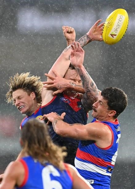 James Harmes of the Demons attempts to mark infront of Tom Liberatore of the Bulldogs during the round 20 AFL match between Melbourne Demons and...