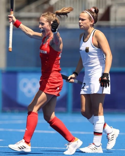 Shona McCallin of Team Great Britain celebrates a goal while Charlotte Stapenhorst of Team Germany looks on during the Women's Pool A match on day...