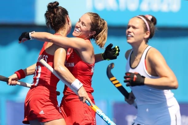 Shona McCallin and Fiona Anne Crackles of Team Great Britain celebrate Team Great Britain's first goal while Charlotte Stapenhorst of Team Germany...