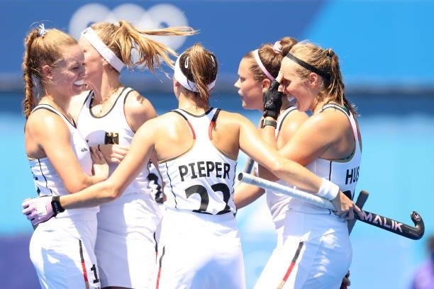 Cecile Pieper and teammates of Team Germany celebrate after their first goal against Team Great Britain during the Women's Pool A match on day two of...