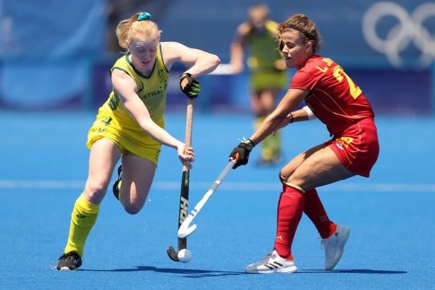 Amy Rose Lawton of Team Australia moves the ball past Lucia Jimenez Vicente of Team Spain during the Women's Pool B match on day two of the Tokyo...