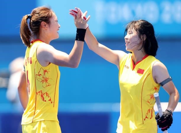 Ying Zhang of Team China celebrates scoring a goal with Jinrong Zhang during the Women's Pool B Match against Team Japan on day two of the Tokyo 2020...