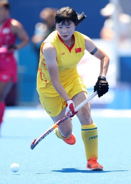Jinrong Zhang of Team China runs upfield with the ball against during the Women's Pool B Match against Team Japan on day two of the Tokyo 2020...
