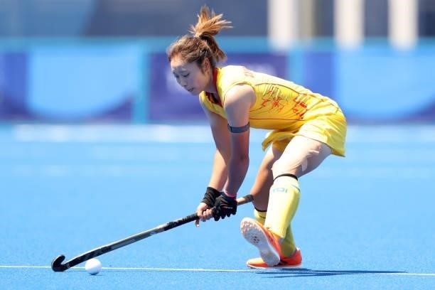 Ying Zhang of Team China passes the ball during the Women's Pool B Match against Team Japan on day two of the Tokyo 2020 Olympic Games at Oi Hockey...