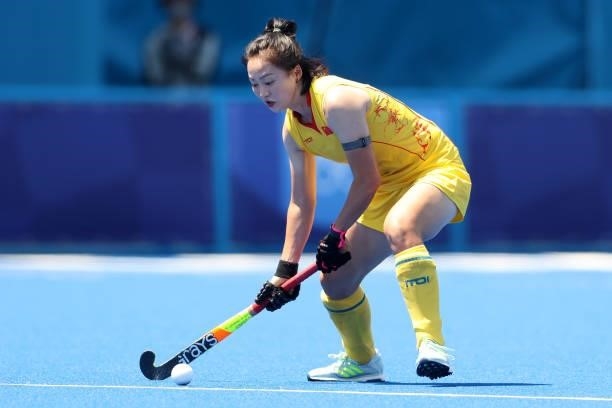 Zixia Ou of Team China controls the ball during the Women's Pool B Match against Team Japan on day two of the Tokyo 2020 Olympic Games at Oi Hockey...
