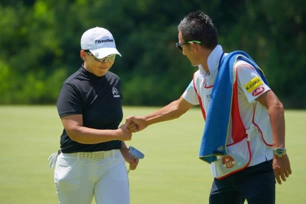 Jiyai Shin of South Korea fist bumps with her caddie after the birdie on the 9th green during the final round of Daito Kentaku eHeyanet Ladies at...