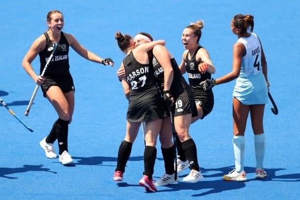 Holly Pearson of Team New Zealand is congratulated by Tessa Jopp and teammates after scoring Team New Zealand's third goal during the Women's Pool B...