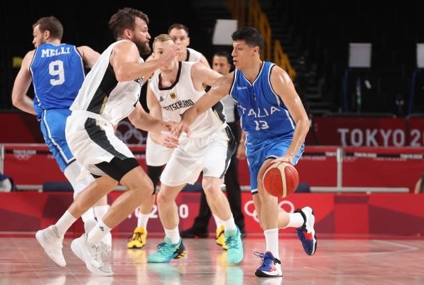 Simone Fontecchio of Team Italy is defended by Danilo Barthel of Team Germany during the first half on day two of the Tokyo 2020 Olympic Games at...