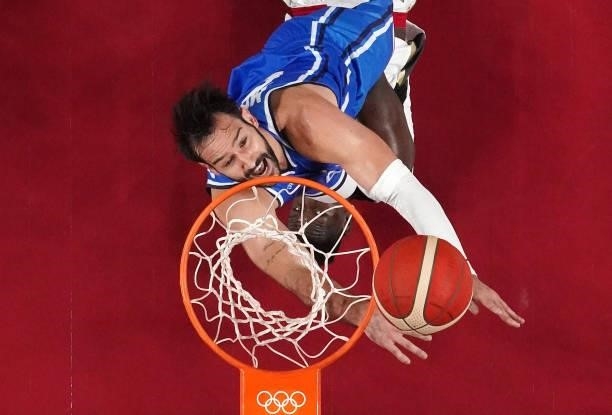 Riccardo Moraschini of Team Italy eyes the ball as Isaac Bonga of Team Germany lays on the court during the first half on day two of the Tokyo 2020...
