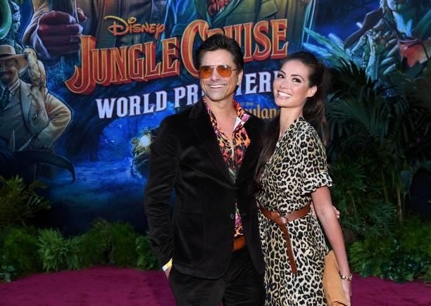 John Stamos and Caitlin McHugh arrive at the world premiere for JUNGLE CRUISE, held at Disneyland in Anaheim, California on July 24, 2021.